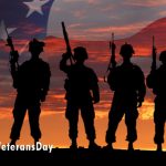 Soldiers standing shadowed in front of American Flag background